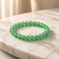 Shri Divya Ratan natural green aventurine crystal bead bracelet on a white marble surface