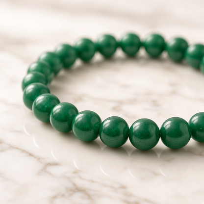 Shri Divya Ratan natural green jade beaded bracelet with 8mm round stones on a white marble surface