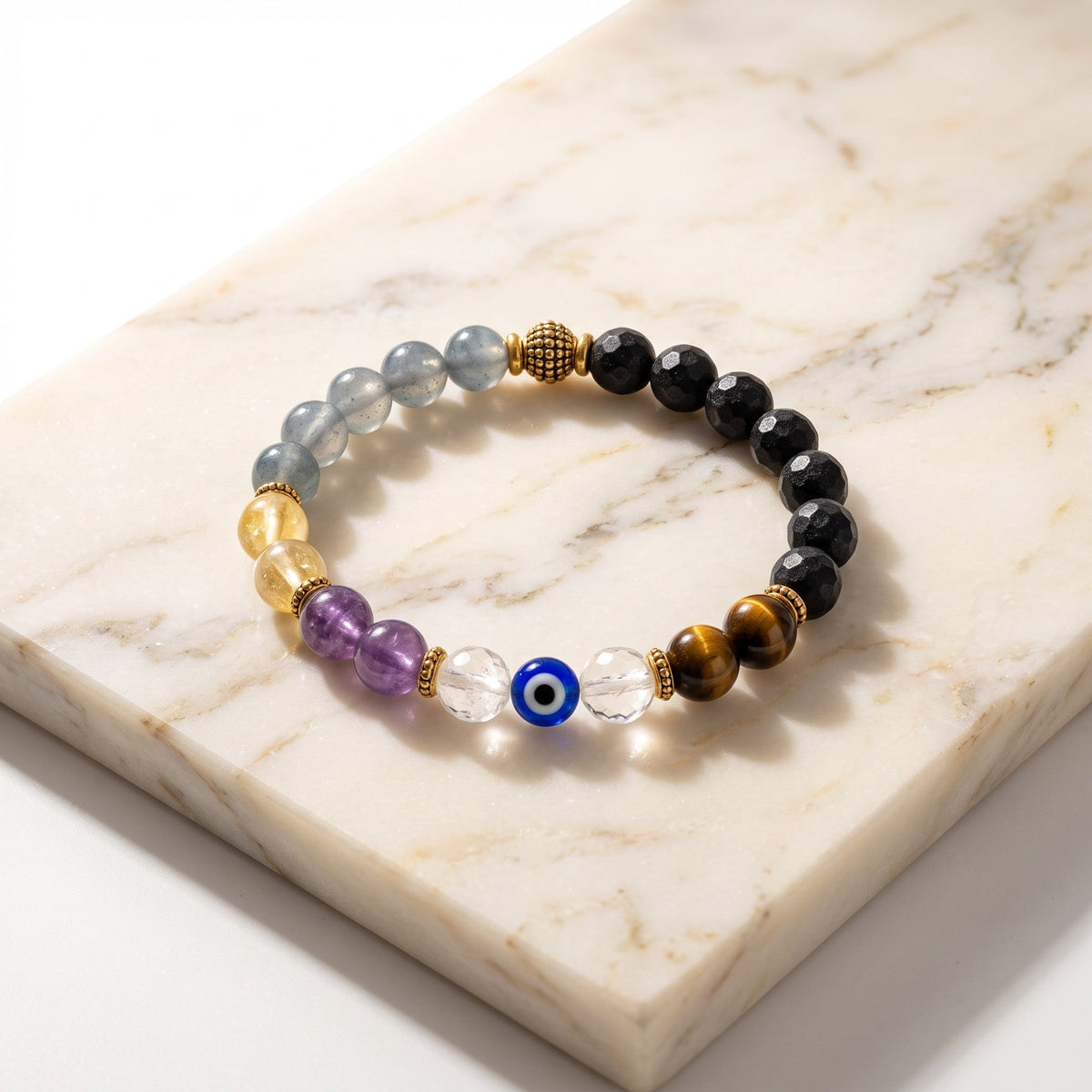 Shri Divya Ratan Nazar protection bracelet featuring 8mm faceted crystals and a central evil eye bead on marble