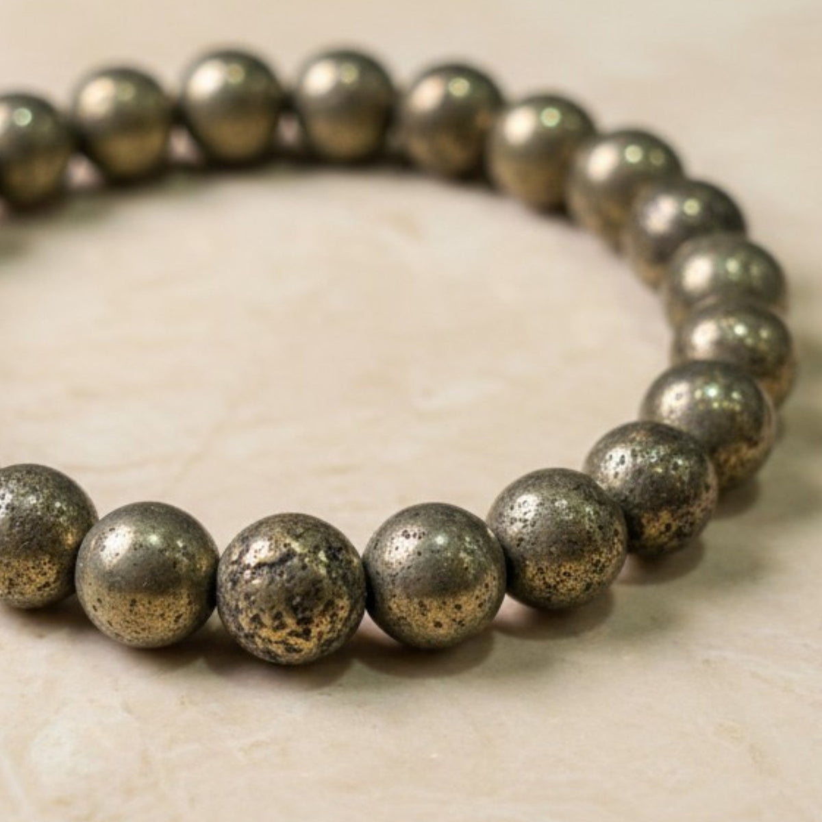 Shri Divya Ratan natural pyrite crystal bead bracelet with metallic golden shimmer on a neutral surface