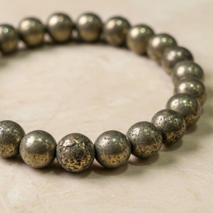 Shri Divya Ratan natural pyrite crystal bead bracelet with metallic golden shimmer on a neutral surface