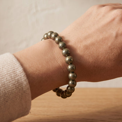 Shri Divya Ratan natural pyrite crystal bead bracelet with metallic gold shimmer worn on a wrist