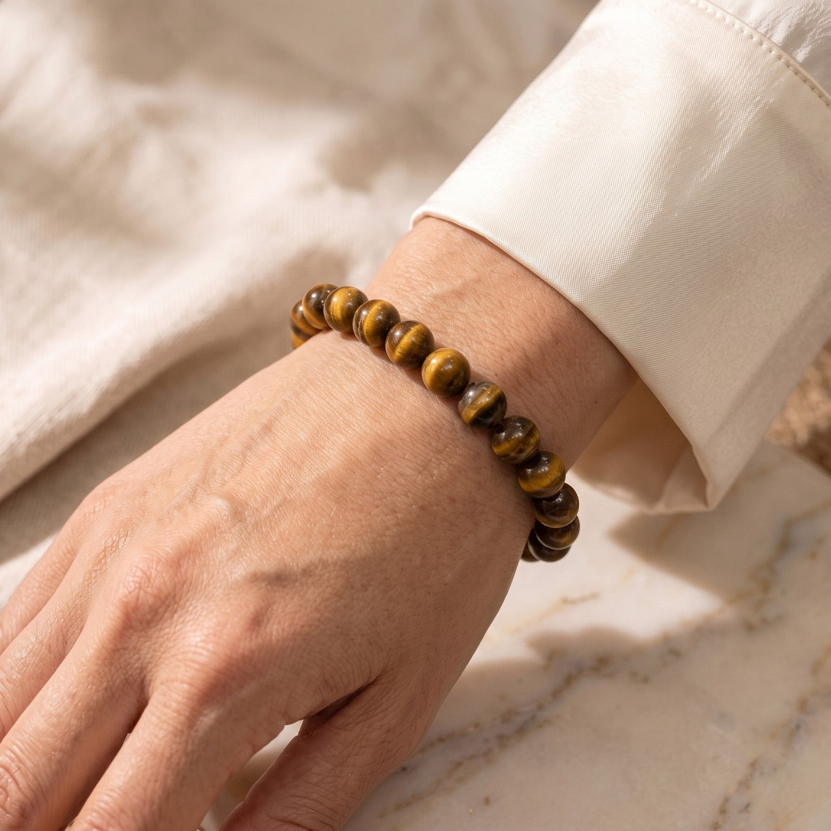 Shri Divya Ratan natural tiger eye crystal bead bracelet with golden-brown chatoyant shimmer worn on a wrist